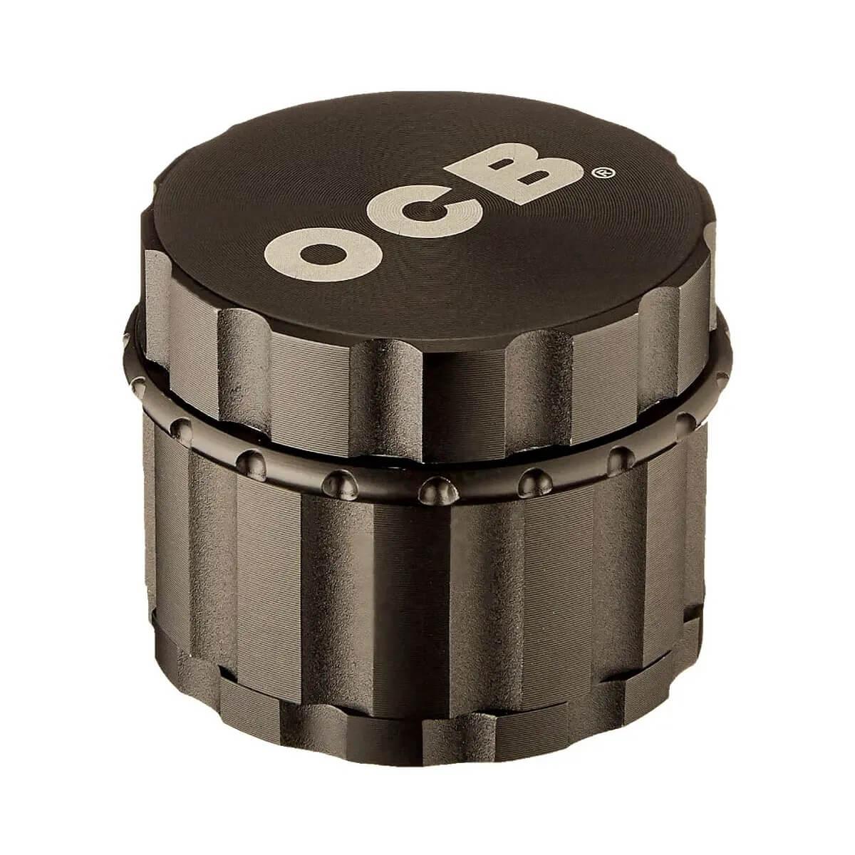 Moledor de metal negro OCB cilíndrico para hierbas, superficie texturizada.