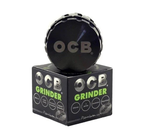 Moledor OCB de 50 mm negro de 4 piezas sobre caja, accesorio para triturar hierbas.